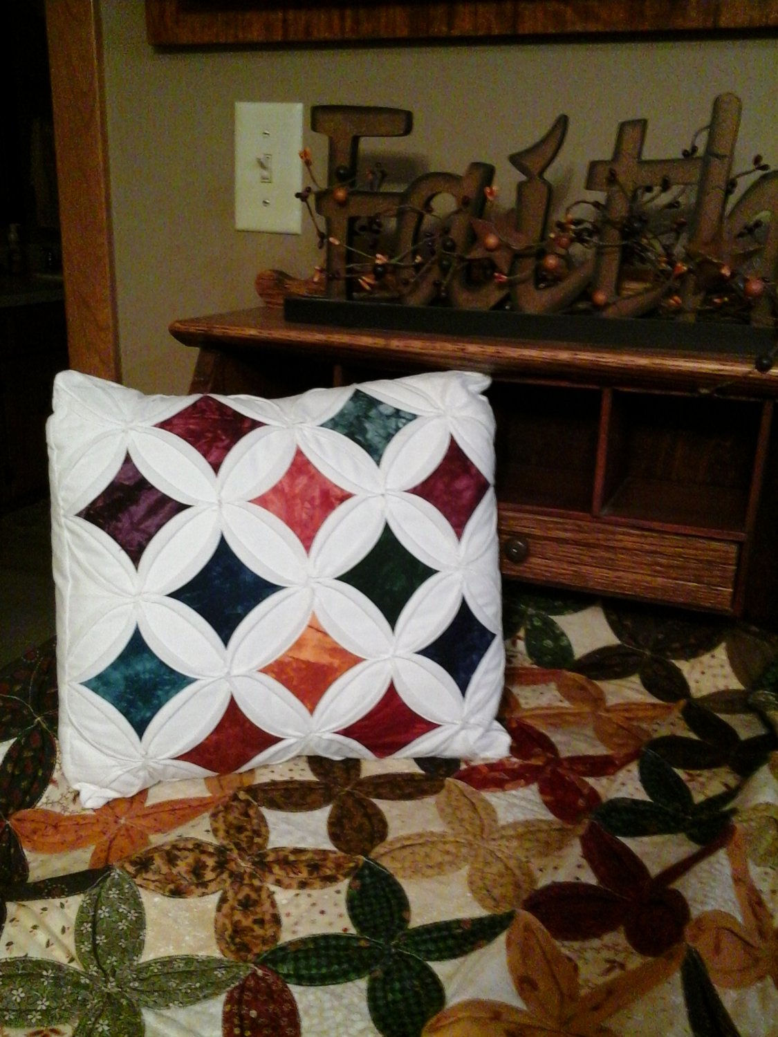 Cathedral Window Pattern Pillow featuring a Cathedral Windows pattern.