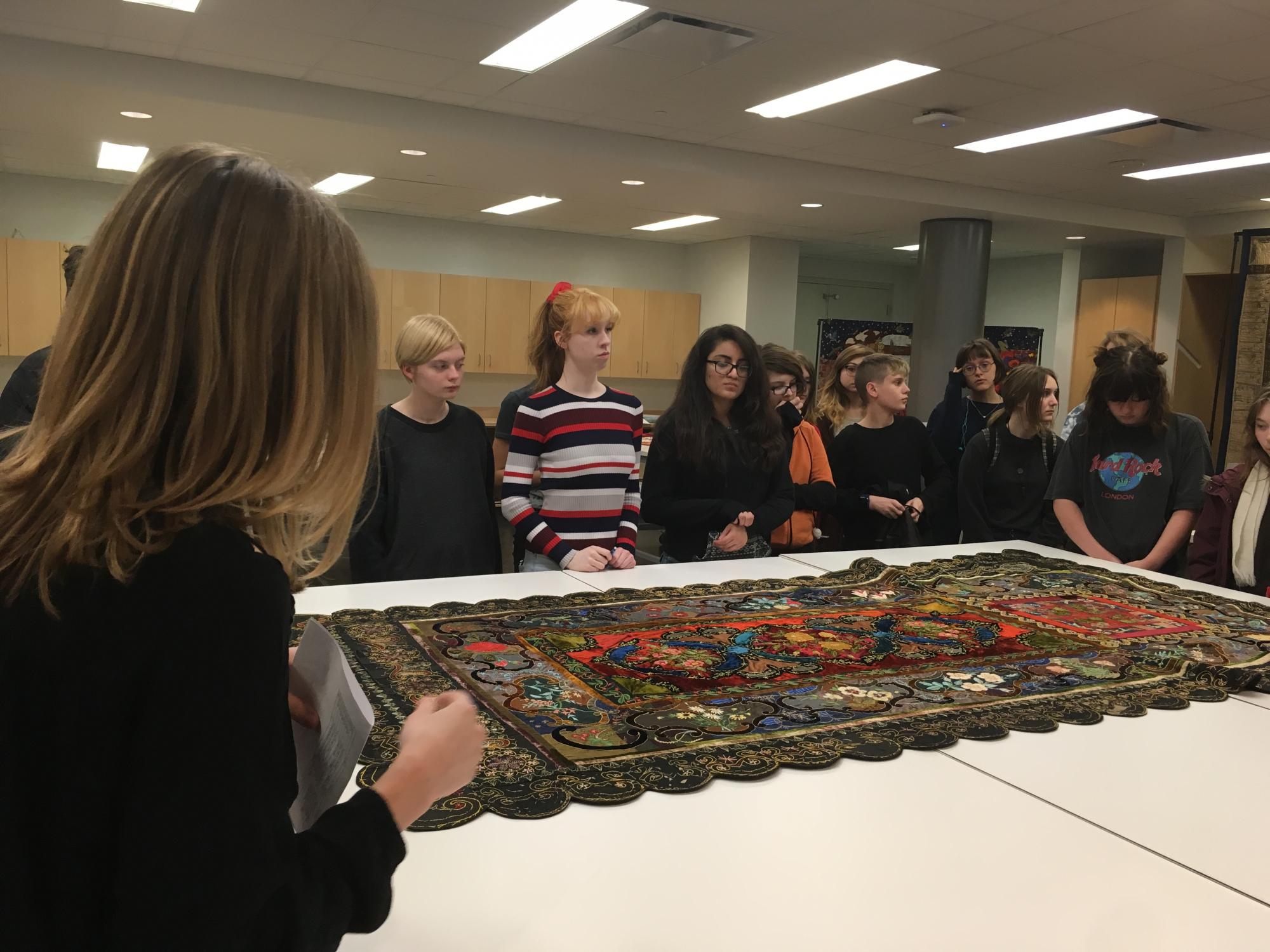 Arts & Humanities at "The Haunting of Quilt House" LPS Arts & Humanities students view a quilted coffin cover during the 2017 pop-up exhibit "The Haunting of Quilt House."