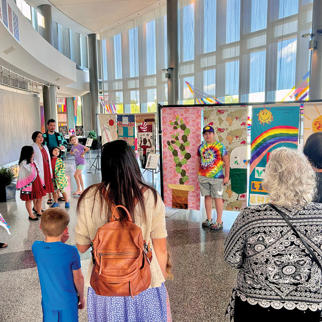 Families gather at the IQM for an all-ages banner project. 