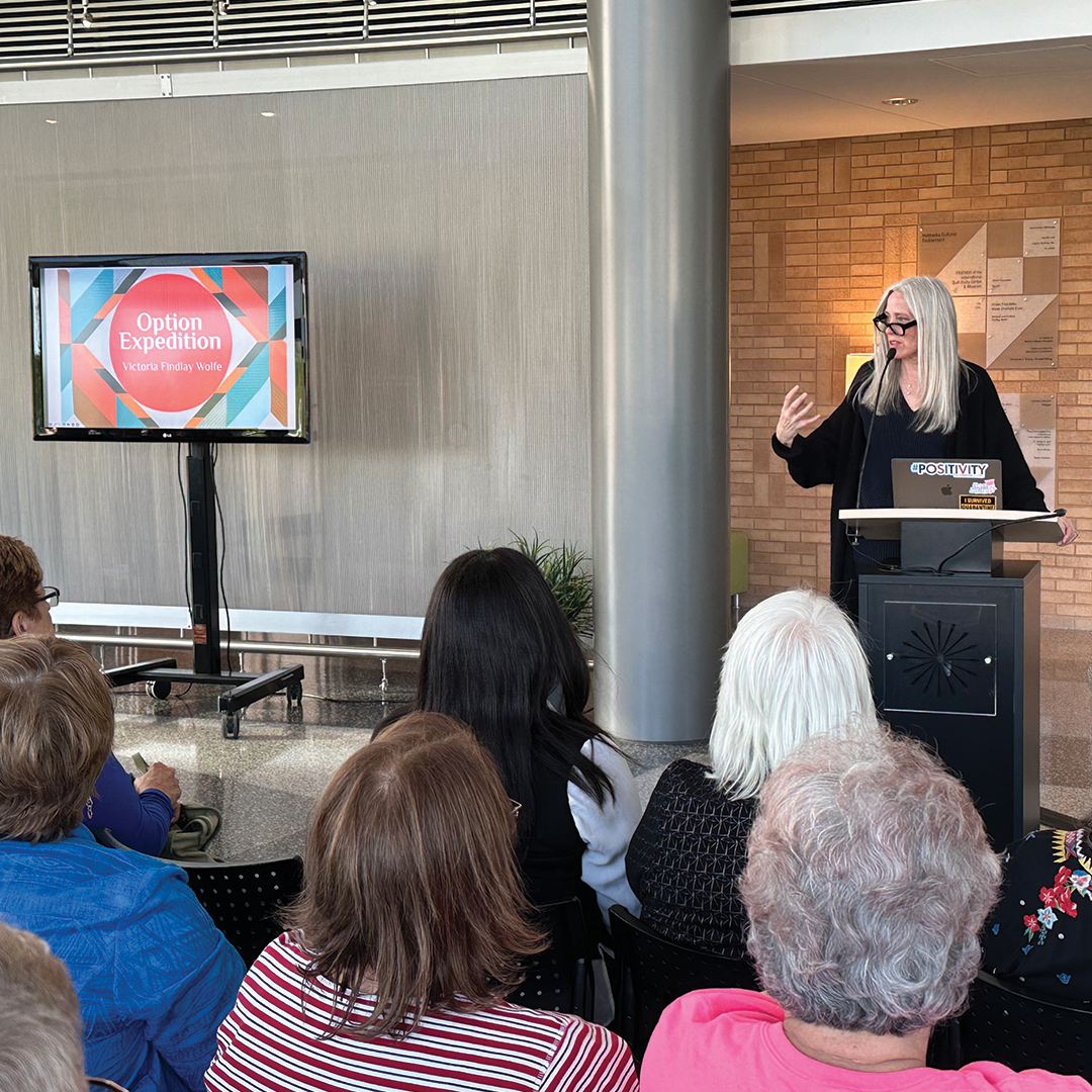 Wolfe at the IQM Photo of Victoria Findlay Wolfe giving a presentation to guests at the IQM.