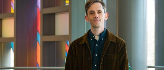Jamie Swartz poses for a photo in the IQM reception hall
